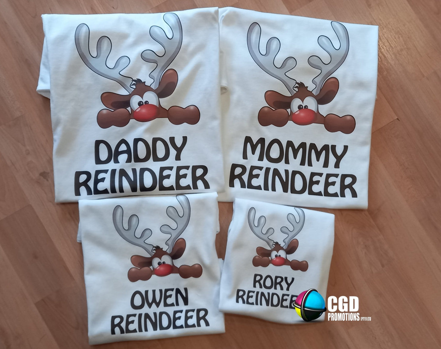 “Family of four wearing Peeping Reindeer Christmas matching family shirts – adult unisex, ladies fitted, and kids tees”