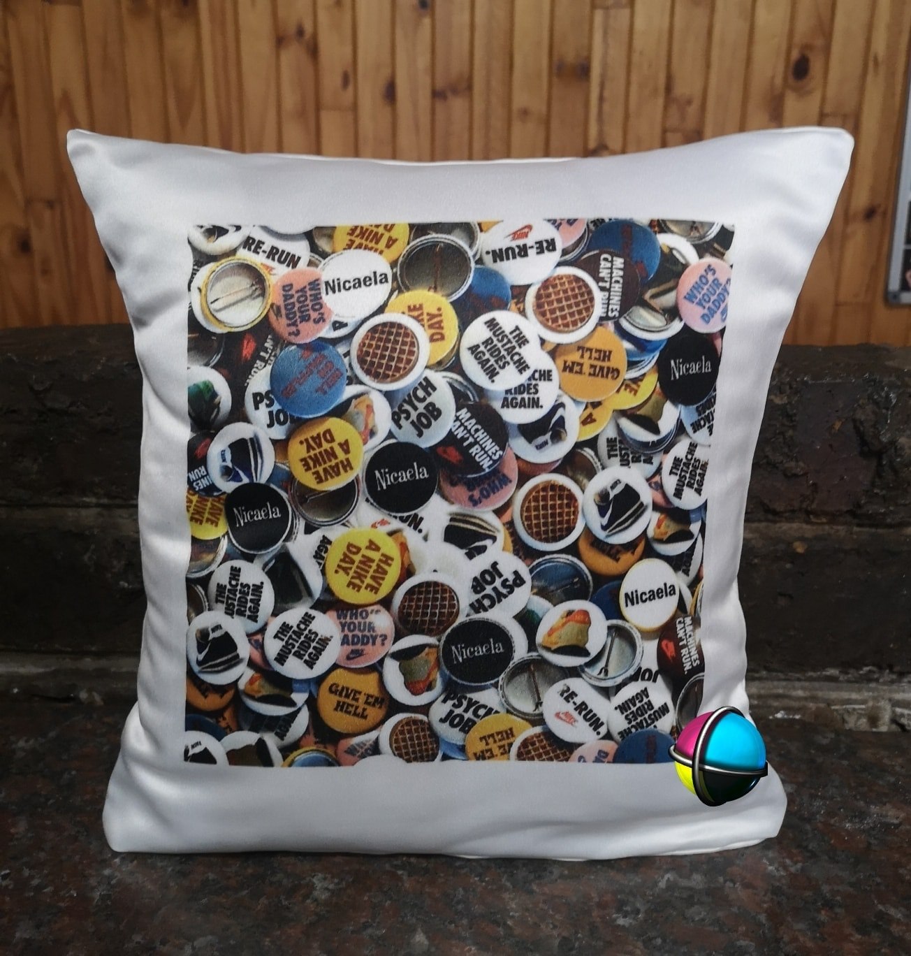 Pillow with colorful button pattern on a wooden background