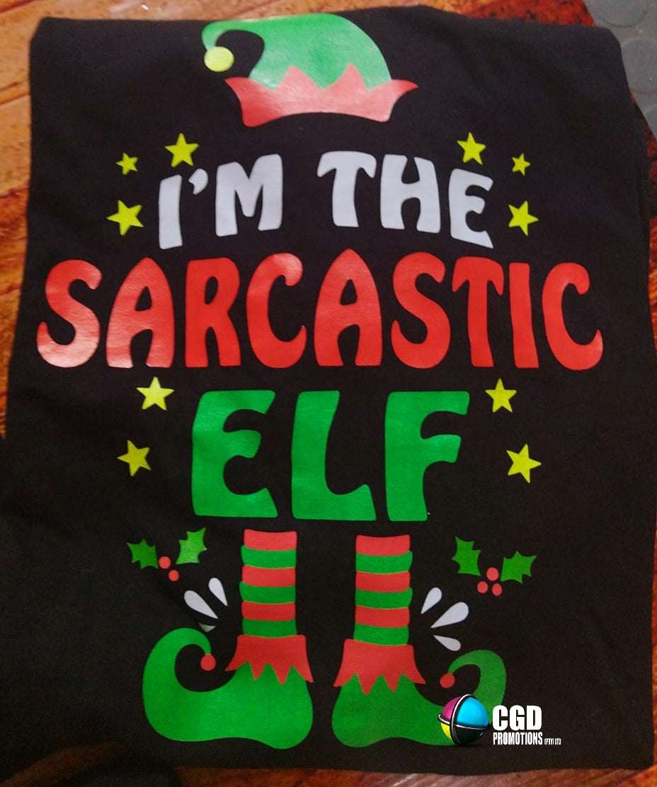 "Custom 'I'm the Elf' Christmas shirts in unisex, ladies' fitted, and kids' sizes, featuring personalized elf titles for each family member on soft, high-quality fabric." I am the sarcastic elf