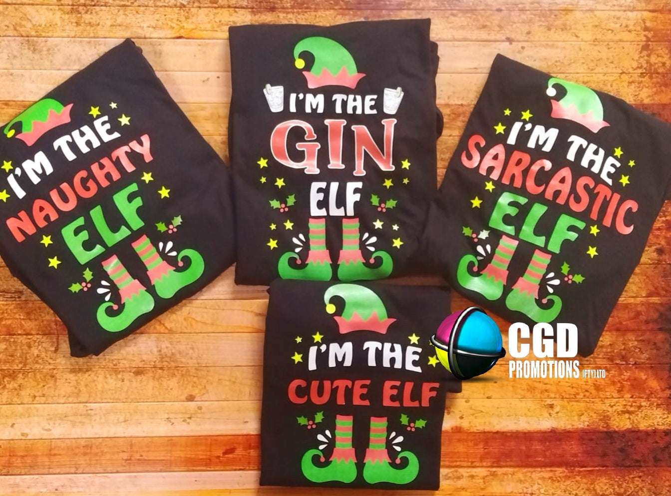 "Custom 'I'm the Elf' Christmas shirts in unisex, ladies' fitted, and kids' sizes, featuring personalized elf titles for each family member on soft, high-quality fabric." I am the sarcastic elf, im the naughty elf, im the cute elf