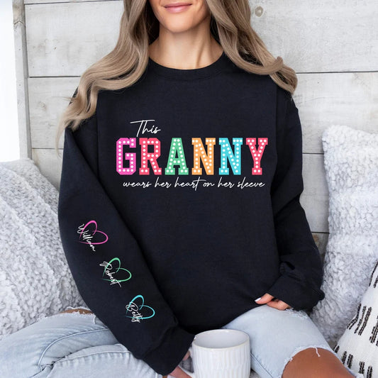 This Mama wears her heart on her sleeve with Children Names on Sleeve Multicolour fonts and hearts Unisex Mother's Day Printed Hoodie / Sweater