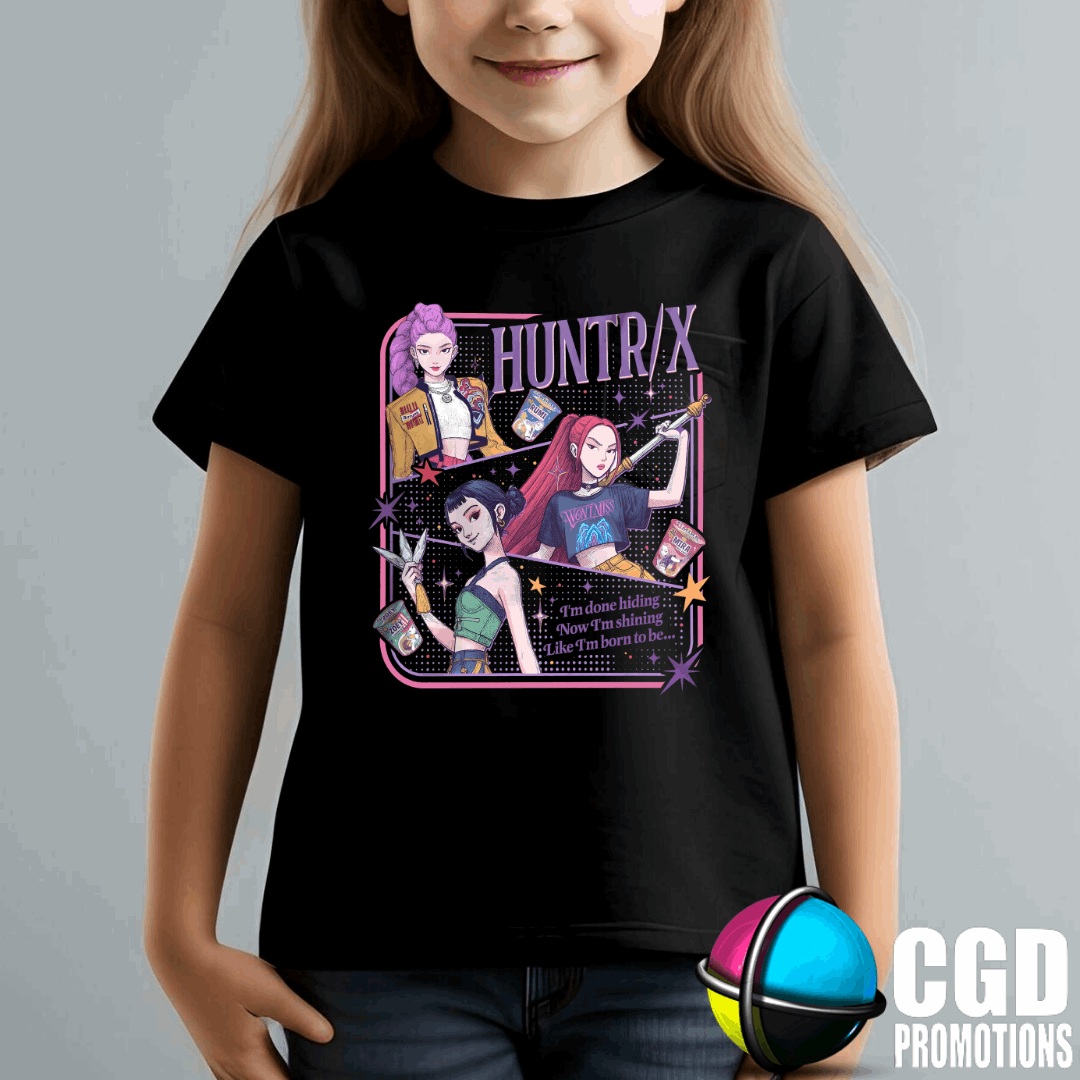 Child wearing a black t-shirt with 'HUNTR/X' graphic design on a gray background im done hiding Now im shinging like im born to be 
