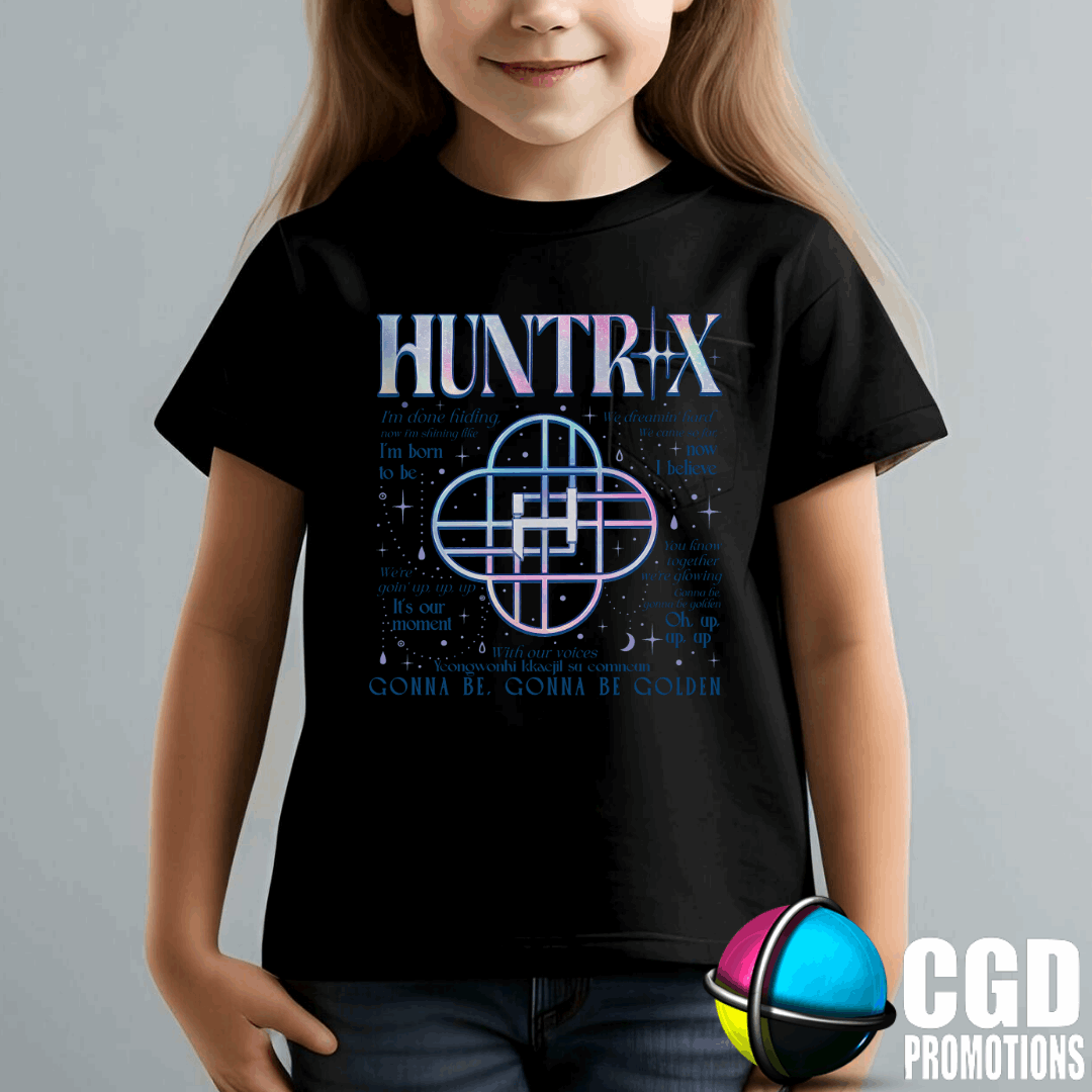 Child wearing a black t-shirt with 'HUNTRIX' design on a gray background
