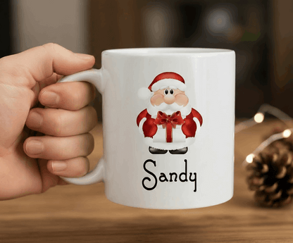Two Christmas-themed mugs with Santa Claus and holiday text on a white background.