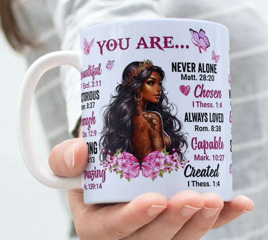 Faith-based ceramic mug with crowned African woman, butterflies, and Bible verse affirmations – “You Are…” Christian gift for women

